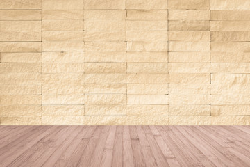 Yellow cream brown rock tile wall with wooden floor in light red brown for interior background ...