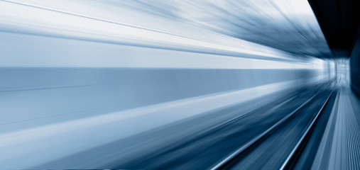 White high speed train runs on rail tracks . Train in motion
