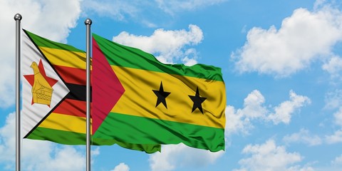 Zimbabwe and Sao Tome And Principe flag waving in the wind against white cloudy blue sky together. Diplomacy concept, international relations.