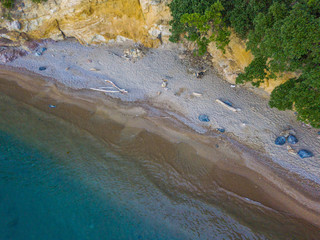 Aerial view of empty beach on remote coast. Waves coming ashore to sandy beach.