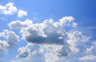 Naklejka na ściany i meble Blue sky and fluffy clouds background.