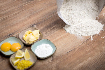 ingredients for a homemade cookie dough or cake, flour on the table