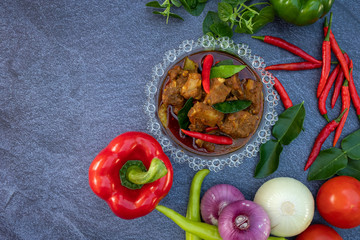Asian food such as Thai red curry top view with copy space.Vegetables and ingredient are around in good cuisine design on the stone background.