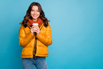 Photo of pretty cute lady holding hot takeout coffee beverage wear stylish autumn windbreaker jeans scarf pullover isolated blue color background © deagreez