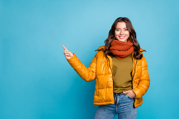 Photo of pretty millennial lady indicating finger empty space sales manager wear modern stylish autumn windbreaker jeans scarf pullover isolated blue color background © deagreez