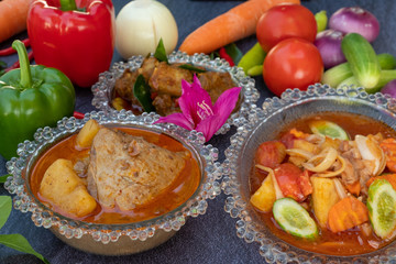 Asian food such as Thai red curry top view with copy space.Vegetables and ingredient are around in good cuisine design on the stone background.