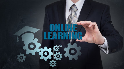 businessman using modern tablet pc and pressing Online learning icon on virtual screen.