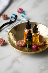 Dermaroller, Handtuch und Beauty Naturkosmetik Serum Öl Flasche zum  Microneedling für Anti Aging Lifting oder Akne Anwendung auf Marmor Hintergrund