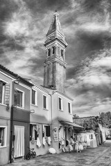 Fototapeta na wymiar The leaning belltower of St Martin Church, Burano, Venice, Italy