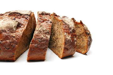 close-up of sliced homemade rye btead with seeds isolated on white background