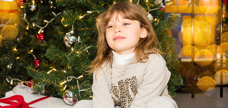 beautiful girl waiting for the opening of gifts