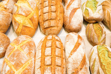 Loafs of fresh bread in bakery shop