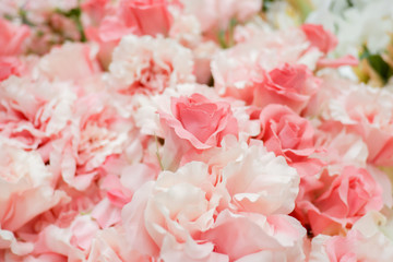 Pastel artificial rose and carnation flowers for background