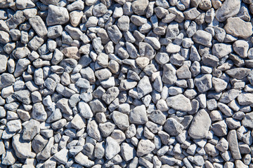 Ground granite stones as gray background.