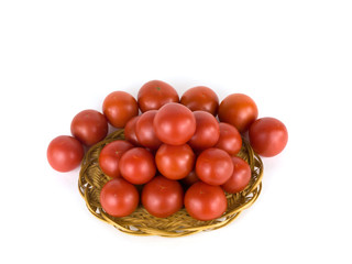 Tomatoes in a basket on a white background