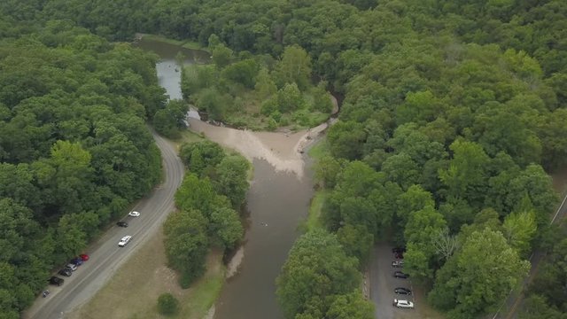 aerial drone footage over bridge and creek in ozark forest