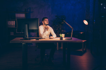 Photo of thoughtful dreamy serious man waiting for his shift to be over having done all necessary...