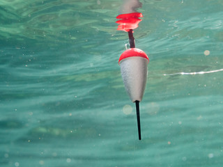 Polystyrene fishing float pulled underwater © Mps197