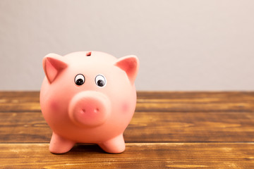 pink piggy bank on wooden background