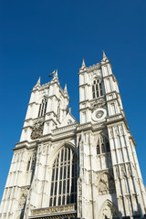 Fototapeta na wymiar Bright sunny exterior view of Westminster Abbey under blue sky in London, UK
