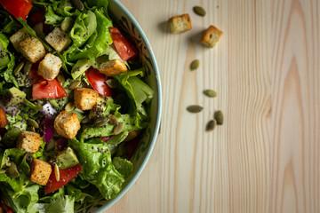 salad with tomatoes, avocados and croutons, close-up