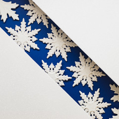 combination of white and blue with white lace snowflakes, shiny holiday background.