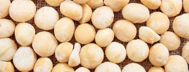 Macadamias nuts full background, closeup view, banner