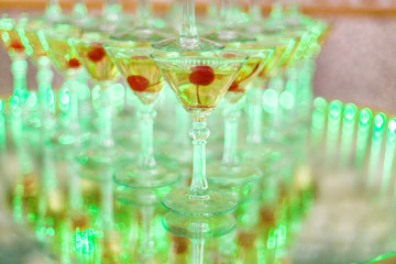 Cascade of champagne from glass goblets on a blurred background