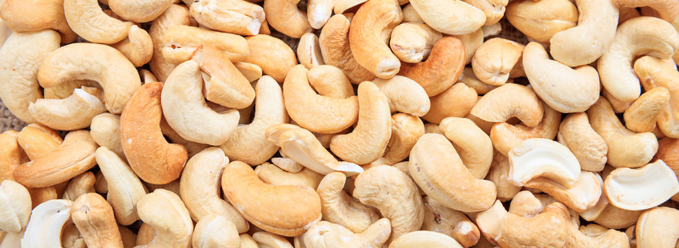 Cashew nuts peeled full background, closeup view, banner