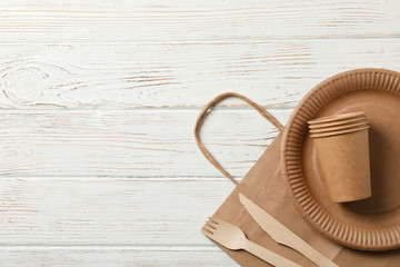 Concept with eco - friendly tableware on wooden background, copy space