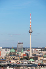 Berlin's iconic Television Tower and the Berlin Cathedral amidst rooftops