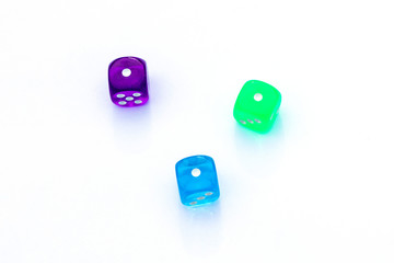 three multi-colored dice with number one on the sides on white background