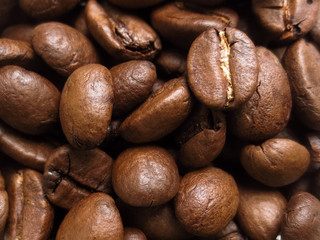Roasted coffee beans. A handful of roasted coffee beans. The texture of roasted coffee beans