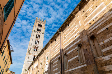 Fototapeta na wymiar Basilica di San Frediano in Lucca, Italy. Old cozy street in Lucca, Italy. Lucca is a city and comune in Tuscany. It is the capital of the Province of Lucca