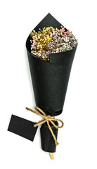 Dried flower bouquet with black paper on white background