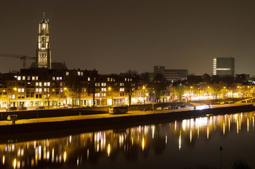 Fototapeta na wymiar Arnhem in the Netherlands, with St. Eusebius church at night with in the foreground the river Rhine