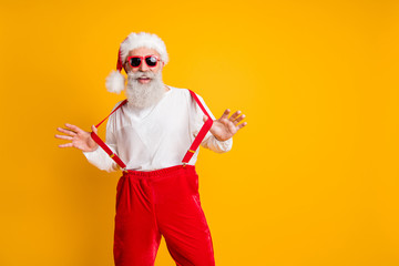 Fototapeta na wymiar Portrait of cool stylish santa claus hipster enjoy newyear time magic festive celebration pull suspenders wear red hat isolated over shine color background