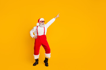 Full body photo of cool crazy funky santa claus hipster enjoy x-mas party celebration club raise hands dance wear shirt suspenders isolated over bright color background