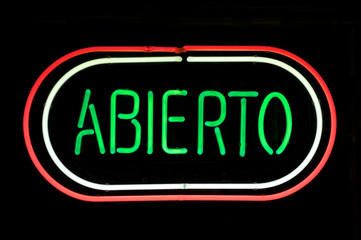 ABIERTO sign (the Spanish word for OPEN) in red, white, and green neon  