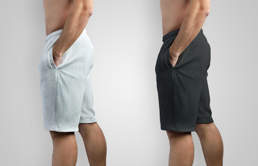Design mockup white and black shorts on a man, side view on an isolated background.