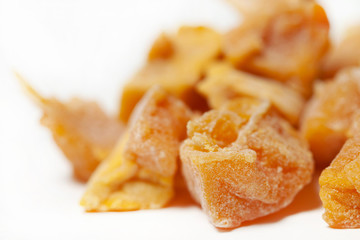 Candied dried sweet fruits slices orange macro closeup white background