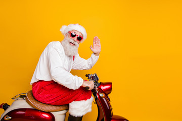 Photo of stylish santa grandpa riding x-mas party retro bike waving arm greeting gesture wear...
