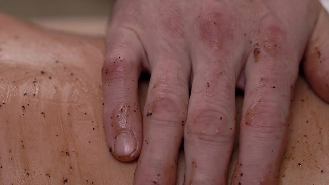 Massage with chocolate scrub and coconut oil to make skin more gentle. Professional body care concept