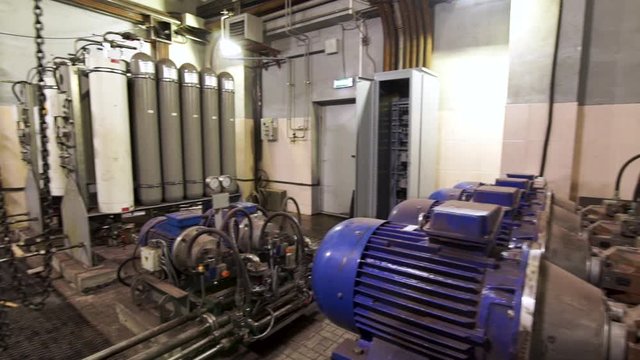 Pipelines, fittings, valves and pumps at the power plant. Stock footage. Different equipment at the compressor station at the factory.