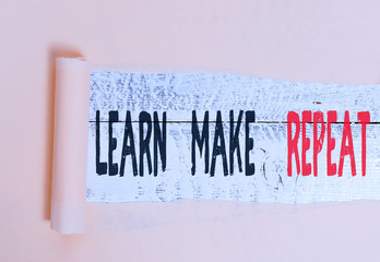 Writing note showing Learn Make Repeat. Business concept for Once you do it will be easy fast learner fix mistakes Cardboard which is torn placed above a wooden classic table