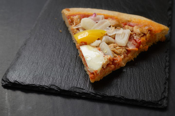 pizza slice with tuna and onion, pepperoni, egg, and frankfurter, served 