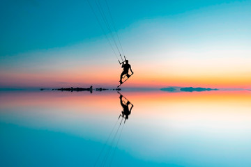 silhouette of man jumping with kitesurf