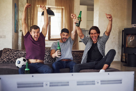 It's A Goal. Excited Three Friends Watching Soccer On TV At Home Together