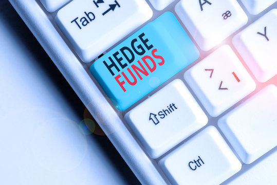 Writing note showing Hedge Funds. Business concept for basically a fancy name for an alternative investment partnership White pc keyboard with note paper above the white background