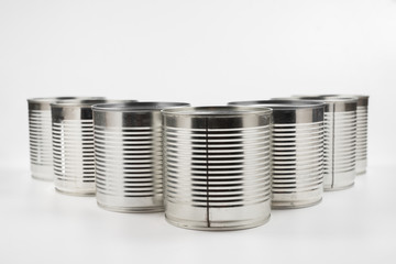 Group of silver canned food on white background.
